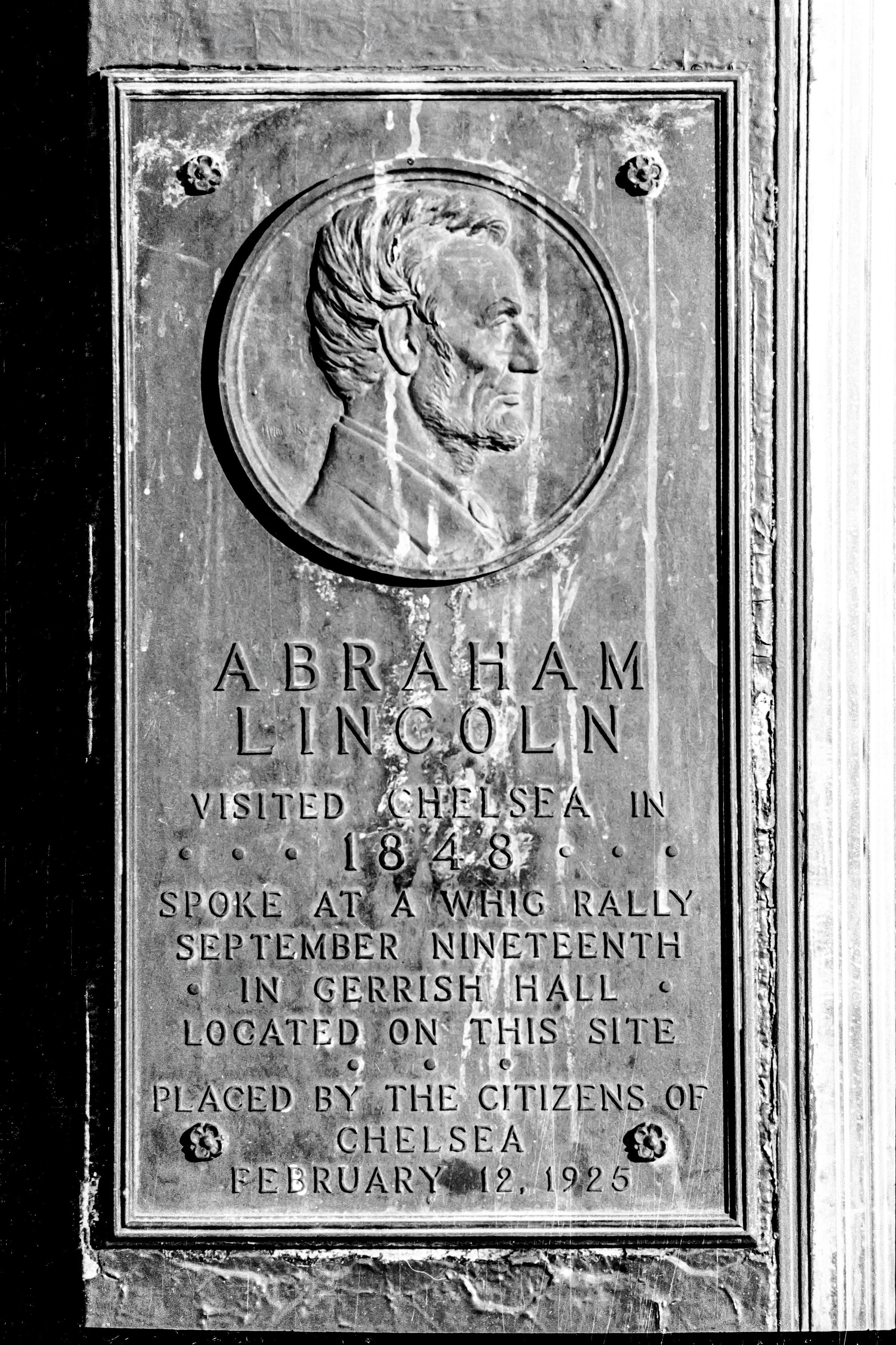 Black-and-white photograph of a weathered Chelsea plaque marking Abraham Lincoln's 1848 visit and speech at Gerrish Hall.