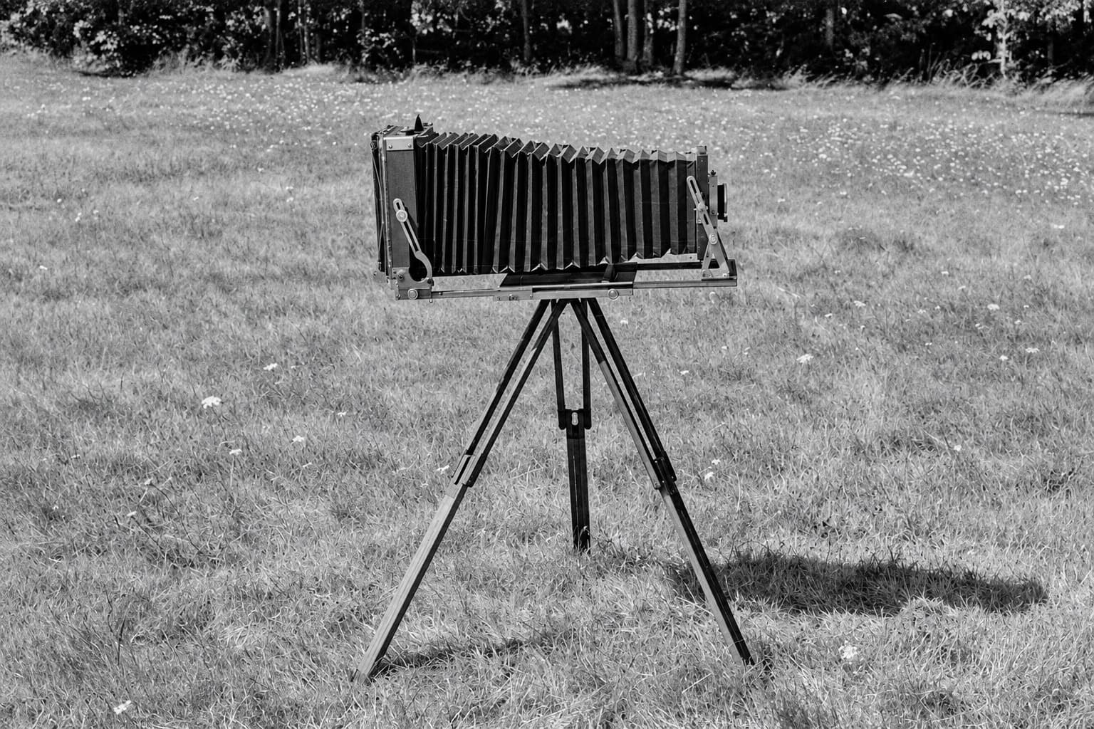 Edited photograph of Arnie Jarmak's Deardorff 8 × 10 field camera on a tripod.