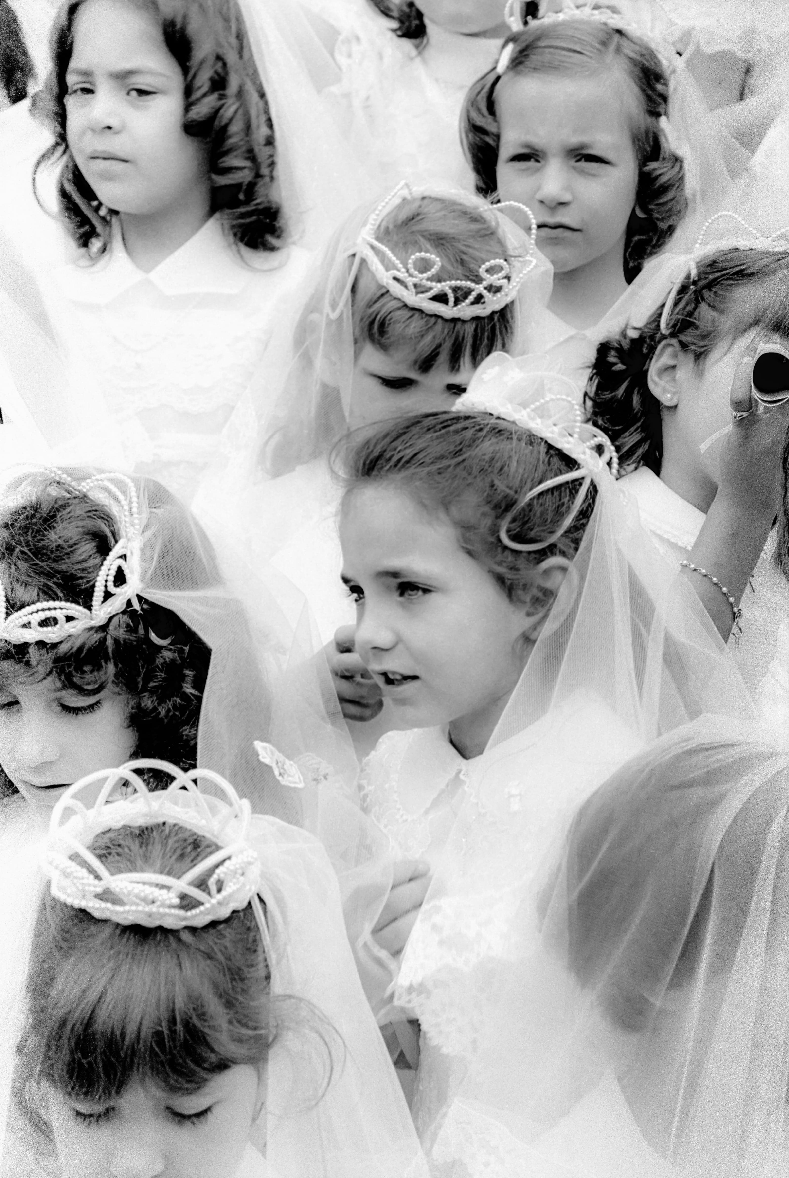 Black-and-white photograph of a closely gathered group of children dressed for First Communion in Chelsea.