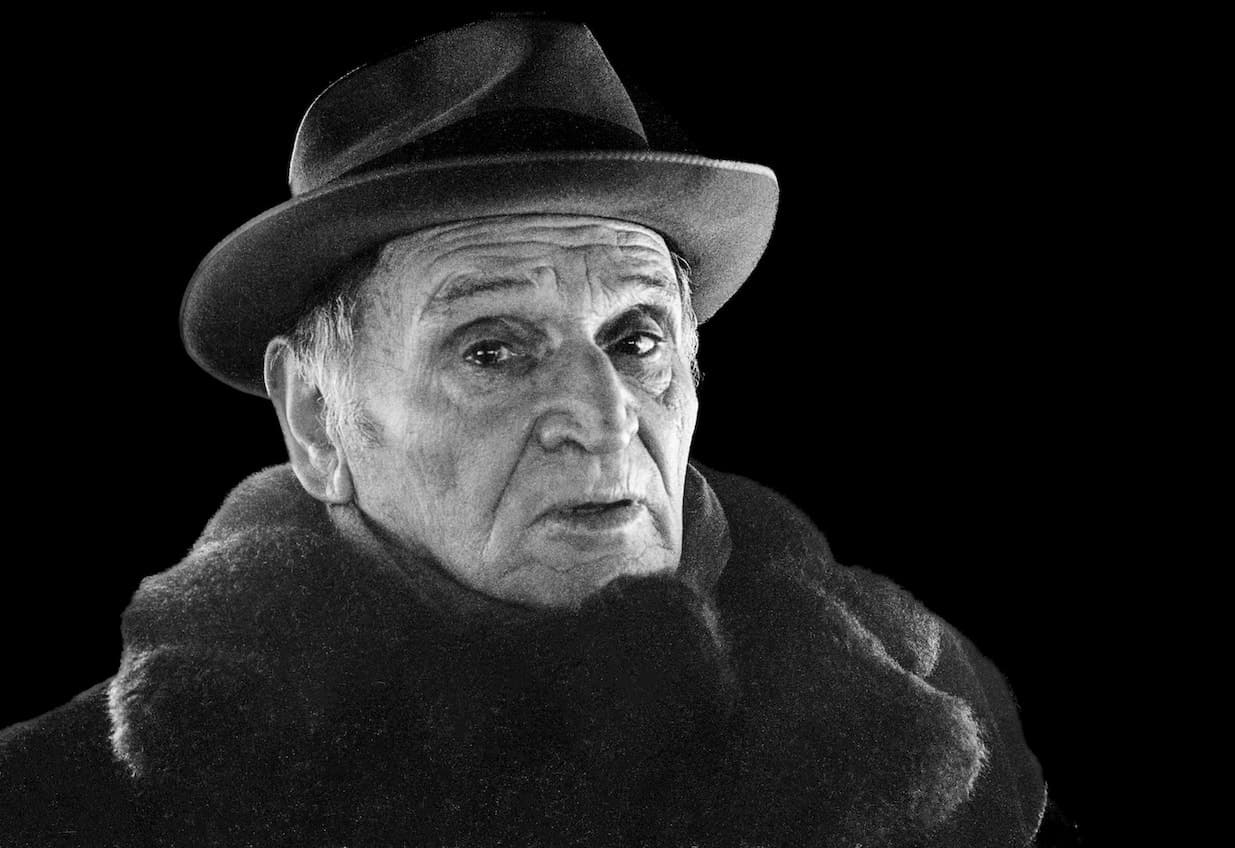 Black-and-white portrait of Jack Shore wearing a dark hat and coat.